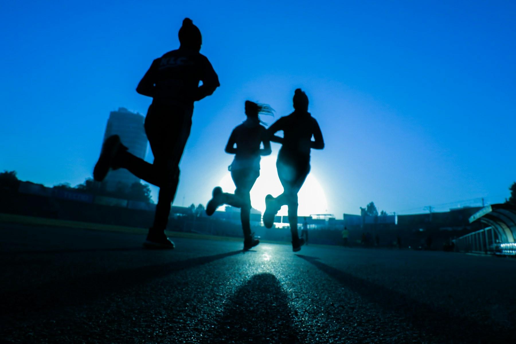 Friends running together outdoors